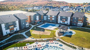 Apartment buildings basketball court volleyball court and pool exterior at Aspen Heights Fayetteville in Fayetteville Student Accommodation