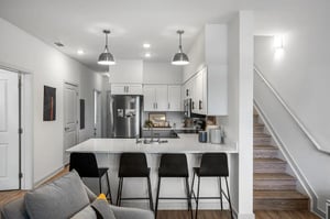 Modern kitchen with stainless steel appliances and bar stools kitchen at Aspen Heights University City in Charlotte Student Accommodation