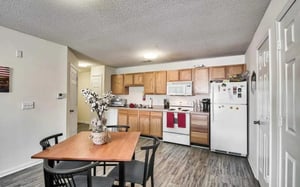 Wooden table with chairs modern kitchen appliances kitchen at Campus Pointe in Kent Student Accommodation