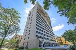 Tall apartment building with windows and trees exterior at Chateau Student Housing Co-op in Minneapolis Student Accommodation