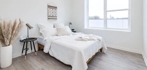 White bed bedside table and pampas grass bedroom at Addams Coliving in Chicago Student Accommodation