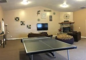 Ping pong table fireplace and seating living room at Brighton Townhouses & Apartments in Rexburg Student Accommodation