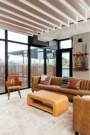 Brown leather sofa armchair pool cues living room at Willow Hall in Dartmouth Student Accommodation