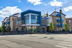 Modern student housing building with blue accents exterior at 65 West in Cincinnati Student Accommodation