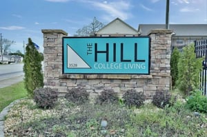 The Hill College Living sign exterior at The Hill Apartments - Student Living in Columbus Student Accommodation