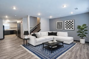 White sectional sofa black coffee table blue rug living room at CitySide By Alexa in Bloomington Student Accommodation