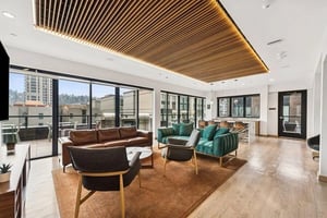 Sofas chairs coffee table and bar living room at Alta Peak in Portland Student Accommodation