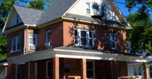 Brick house with porch and trees exterior at Coady Rentals in Athens Student Accommodation