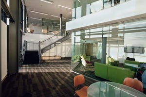 Modern common area with seating stairs and glass living room at Collegetown Terrace Apartments in Ithaca Student Accommodation