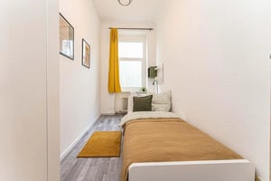 Bed with pillows rug framed art yellow curtain Bedroom at Room in Krowelstraße, 13581 Berlin-Bezirk Spandau, Germany in Berlin Student Accommodation