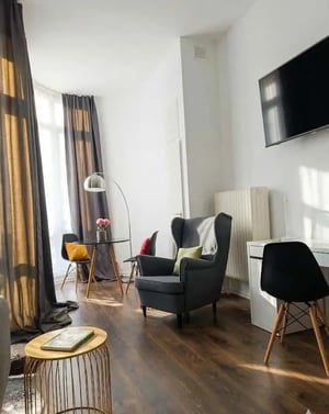 Armchair table chairs TV desk living room at Studio in Tauroggener Str. 7, 10589 Berlin, Deutschland in Berlin Student Accommodation