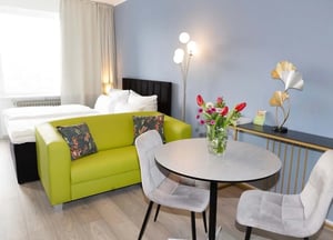 Bed sofa table and chairs living room at Studio in Landhausstraße 10, 10717 Berlin, Deutschland in Berlin Student Accommodation