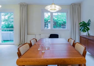 Wooden dining table with chairs and plants dining area at Apartment in Almstadtstraße, 10119 Berlin, Germania in Berlin Student Accommodation