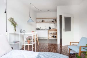 Studio apartment with kitchen living area and chair at Studio in Rochstraße, 10178 Berlin, Germania in Berlin Student Accommodation