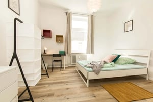 Bed with patterned bedding and pillows bedroom at Room in Kantstraße, 10627 Berlin, Germany in Berlin Student Accommodation