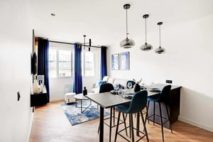 Dining area with bar stools and sofa living room at Apartment in 8 Rue Brey, 75017 Paris, France in Paris Student Accommodation