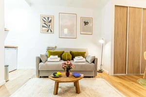 Sofa with pillows fruit and art living room at Studio in 130 Rue du Faubourg Saint-Martin, 75010 Paris, France in Paris Student Accommodation
