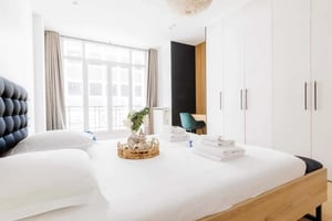 Bed with folded towels and vase bedroom at Apartment in 7 Rue Treilhard, 75008 Paris, France in Paris Student Accommodation