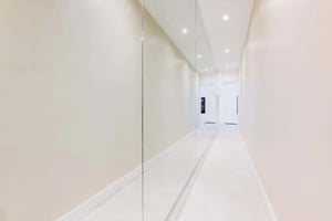 Mirrored hallway with tiled floor and ceiling lights hallway at Apartment in 10 Rue Sedillot, 75007 Paris, France in Paris Student Accommodation
