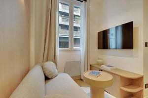 Sofa TV and table in living room at Studio in 82 Rue de l'Assomption, 75016 Paris, France in Paris Student Accommodation