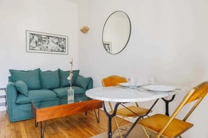 Green sofa marble table orange chairs living room at Apartment in 102 Av. de Saint-Mandé, 75012 Paris, France in Paris Student Accommodation