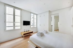Bed TV wardrobe and towels bedroom at Studio in 9 Rue Mandar, 75002 Paris, France in Paris Student Accommodation