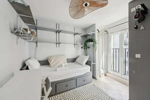 Daybed with pillows and shelves study desk bedroom at Studio in 158 Rue Saint-Maur, 75011 Paris, France in Paris Student Accommodation
