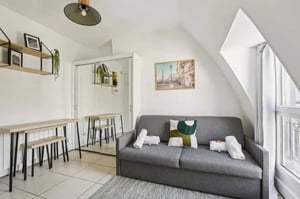 Sofa bed coffee table and shelving living room at Studio in 83 Rue de Dunkerque, 75009 Paris, France in Paris Student Accommodation