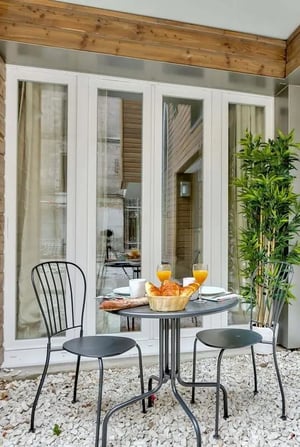 Table with chairs croissants and orange juice exterior at Studio in 14 Rue de la Villette, 75019 Paris, France in Paris Student Accommodation