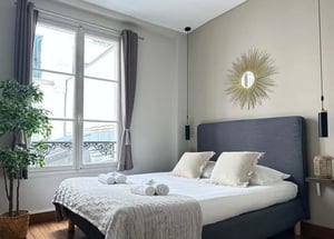 Bed with towels and plant bedroom at Studio in 16 Rue Pavée, 75004 Paris, France in Paris Student Accommodation