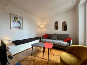 Sofa bed art two tables yellow armchair living room at Apartment in 59 Rue Raymond Losserand, 75014 Paris, France in Paris Student Accommodation