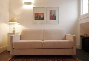 Cream sofa two pictures lamp and chest of drawers living room at Studio in 49 Rue Jean de la Fontaine, 75016 Paris, France in Paris Student Accommodation