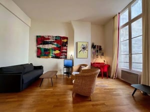 Sofa coffee table chairs TV desk art living room at Apartment in 30 Rue Michel le Comte, 75003 Paris, France in Paris Student Accommodation