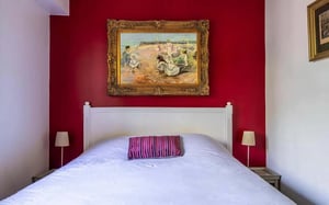 Bed lamps painting and pillows bedroom at Apartment in Rue Cino del Duca, 75017 Paris, France in Paris Student Accommodation