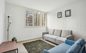 Grey sofa blue chair rug and desk Living room at Apartment in Rue de la Chapelle, 75018 Paris, France in Paris Student Accommodation