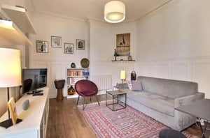 Grey sofa and armchair living room living room at Apartment in Rue Beaunier, 75014 Paris, France in Paris Student Accommodation