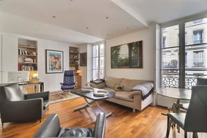 Sofa chairs table shelves art living room at Apartment in Rue des Abbesses, 75018 Paris, France in Paris Student Accommodation
