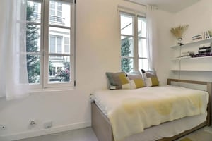 White dining table chairs modern kitchen yellow sofa living room at Studio in Rue Séguier, 75006 Paris, France in Paris Student Accommodation
