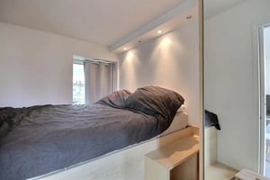 Bed with grey duvet and window beside bedroom at Apartment in Rue de Courcelles, 75017 Paris, France in Paris Student Accommodation