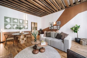 Dining table and sofa in a living room living room at Apartment in 13 Rue Montorgueil, 75001 Paris, France in Paris Student Accommodation