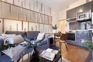 Grey sofa black coffee table modern kitchen living area at Apartment in 30 Rue des Fossés Saint-Bernard, 75005 Paris, France in Paris Student Accommodation