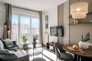 Sofa TV dining table with chairs living room at Apartment in 146 Bd de Grenelle, 75015 Paris, France in Paris Student Accommodation