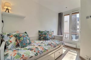 Daybed with floral bedding and pillows bedroom at Studio in Rue Léon Frot, 75011 Paris, France in Paris Student Accommodation