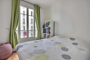 Bed green curtains bookshelf and basket bedroom at Apartment in Rue Gustave Rouanet, 75018 Paris, France in Paris Student Accommodation