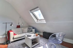 White sofa coffee table chairs and radiator living room at Studio in Rue du Faubourg Saint-Honoré, 75008 Paris, France in Paris Student Accommodation