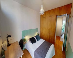 Bed pillows blanket wooden wardrobe bedroom at Chambre dans le rue du Dr Finlay in Paris Student Accommodation