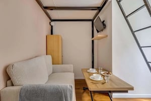 Sofa cabinet table with dishes television living room at Studio in 41 Av. du Maréchal Lyautey, 75016 Paris, Francia in Paris Student Accommodation
