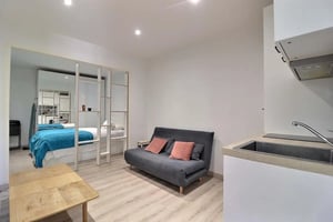 Bed sofa and kitchen area living room at Studio in Rue Myrha, 75018 Paris, France in Paris Student Accommodation