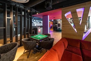 Mahjong table chairs neon sign reception communal area at Vita Student Park Place in Cardiff Student Accommodation