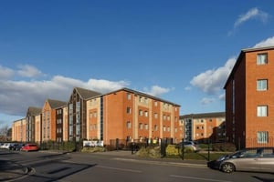 Brick student accommodation buildings with parking exterior at St Peters Court in Nottingham Student Accommodation